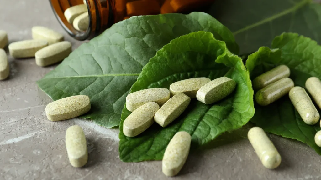 Some herbal supplement pills on green leaves