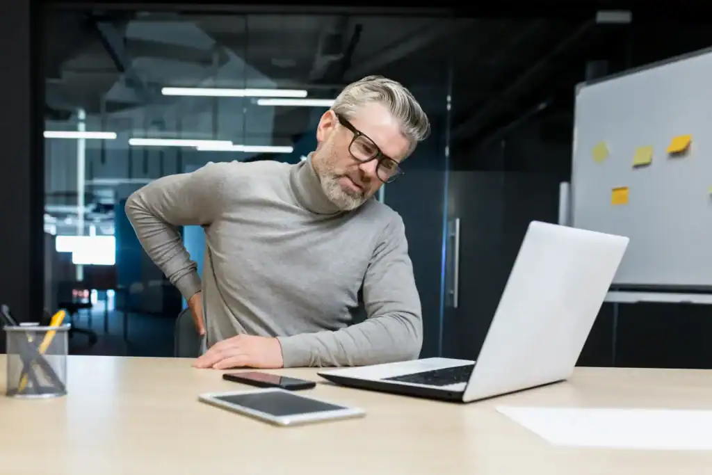 sick-senior-man-working-inside-office-modern-build